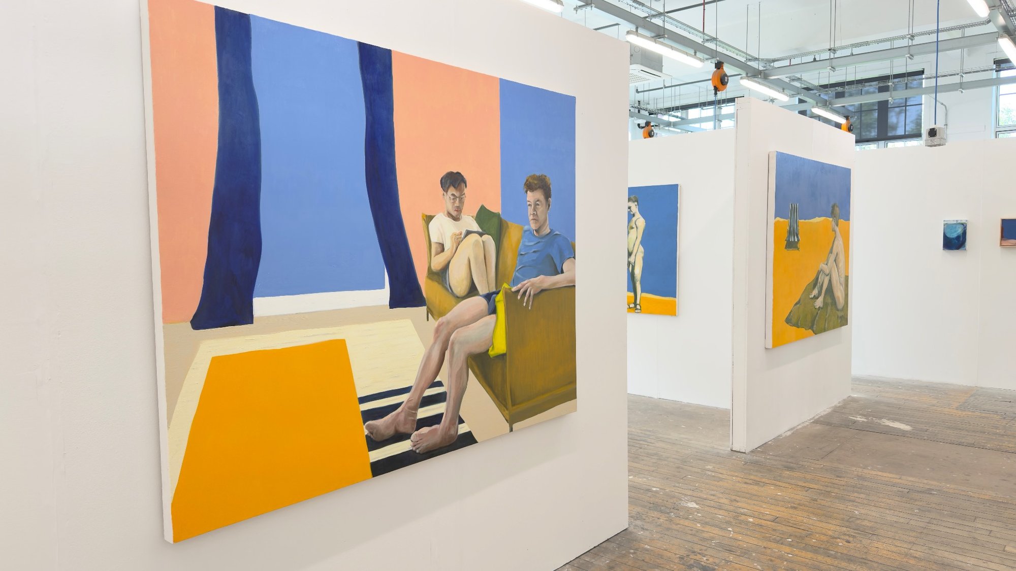 Installation view of Alan Brash’s degree show space with large canvases on freestanding walls.