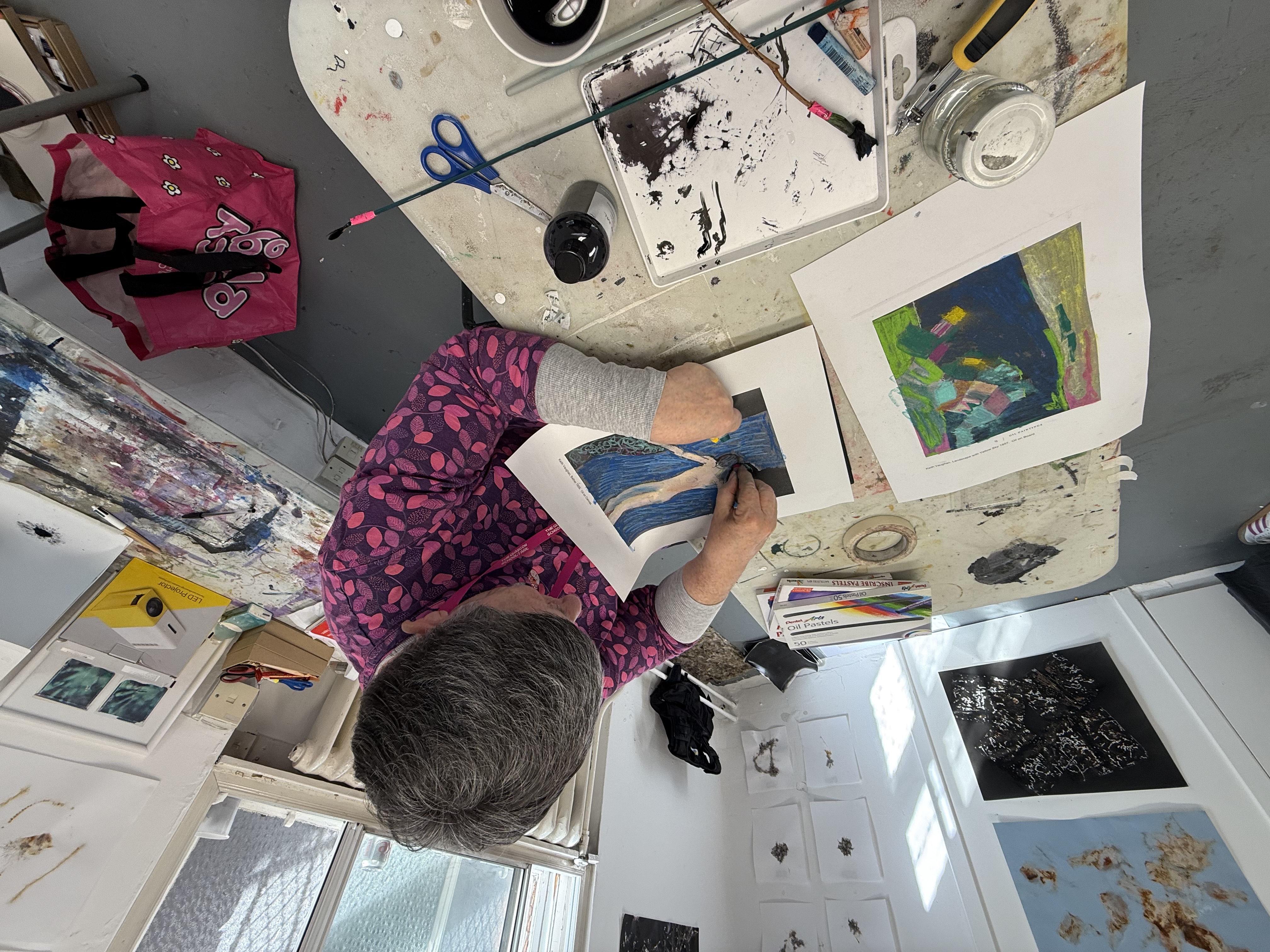Workshop participants working with drawings and materials during a studio-based session.